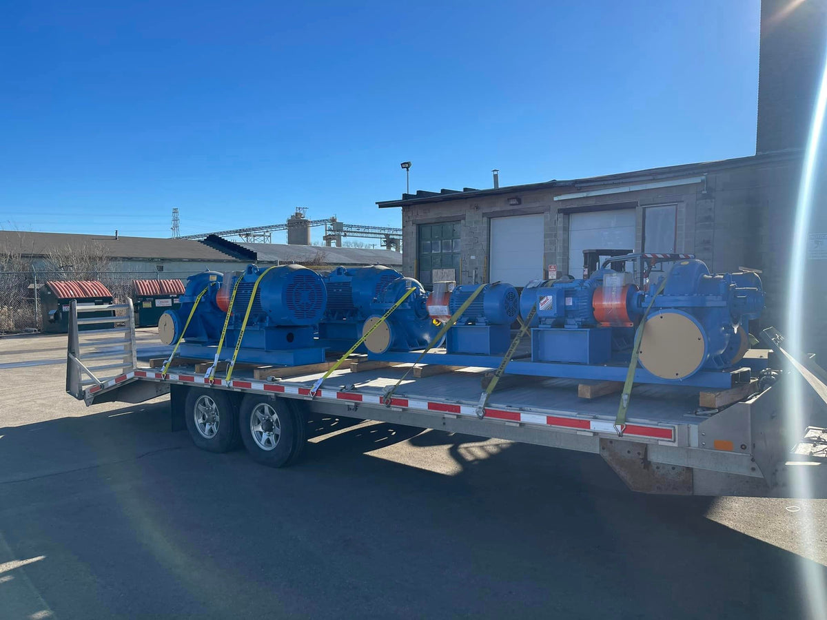 Freshly rebuilt industrial pump and motor skids loaded for delivery at DWP Industrial Sales